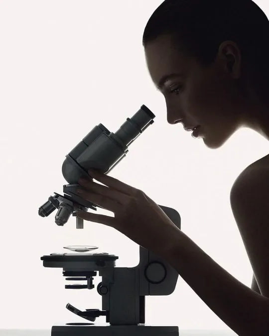 Researcher at a microscope — illustrative laboratory image